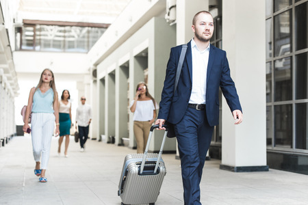 passengers businessmen travel with luggage. People at the airport, boarding a planeの写真素材