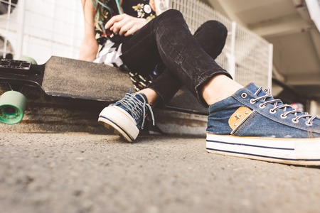 young girl with tattoo and dreadlocks on urban industrial backgroundの写真素材