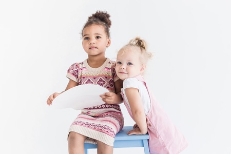 Two little girls playing on a white backgroundの写真素材