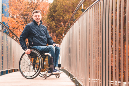 Man in a wheelchair use a wheelchair ramp.の写真素材