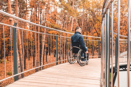 Man in a wheelchair use a wheelchair ramp.の写真素材