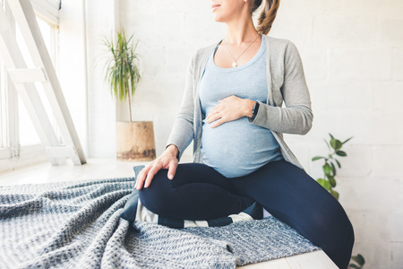 pregnancy, gynecology, medicine, health care and people concept - Pregnant woman keeps bellyの写真素材