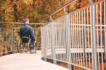 Man in a wheelchair use a wheelchair ramp.の写真素材