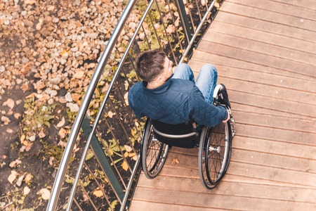 Man in a wheelchair use a wheelchair ramp.の写真素材