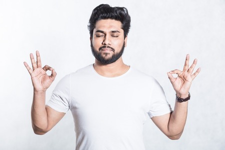 Handsome young man shows ok sign. Body language concept.の写真素材