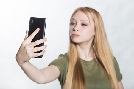 Beautiful young woman taking selfie on smartphone.の写真素材