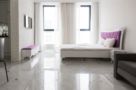 The interior of a modern apartment in a bright Scandinavian style with a color accent, a sofa and a bedの写真素材