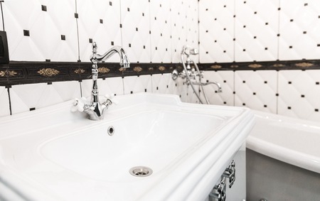 Bathroom interior in art deco style. Classic bathroom and washbasin in combination with beautiful...