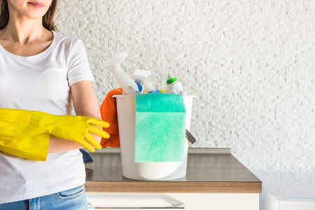 professional home cleaning. A young woman cleans the apartment. Close-up, rags, sponges and bucket, supplies staff.の写真素材