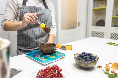 Confectioner prepares a chocolate biscuit cake decorating cream. The concept of homemade pastry, cooking cakesの写真素材