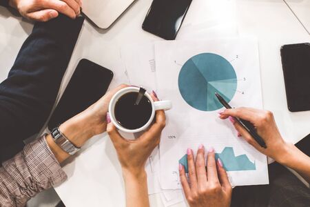top view work workplace. A team of young office workers, businessmen with laptop working at the table, communicating together in an office. Corporate businessteam and manager in a meeting. coworkingの写真素材