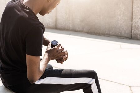 Athletic young afroamerican man running on the promenade. Black Male runner sprinting outdoors. Healthy lifestyle concept.の写真素材
