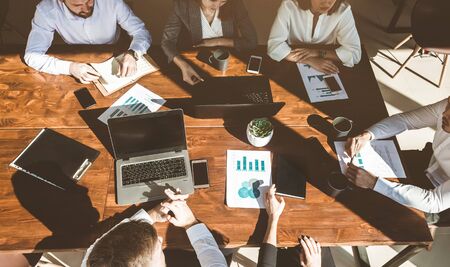 A team of young businessmen working and communicating together in an office. Corporate businessteam and manager in a meetingの写真素材