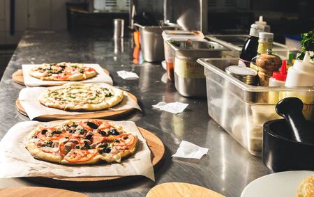 Professional chef cooking in the kitchen restaurant at the hotel, preparing dinner. A cook in an...