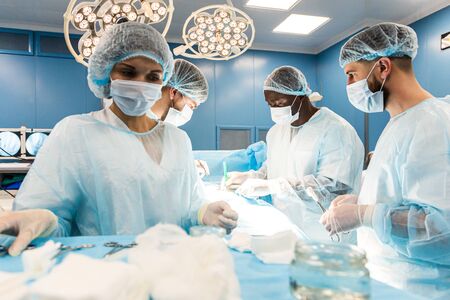 The senior surgeon in the operating room, where the patient is waiting for him, and he begins the...