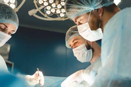 The senior surgeon in the operating room, where the patient is waiting for him, and he begins the...