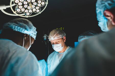 The senior surgeon in the operating room, where the patient is waiting for him, and he begins the...