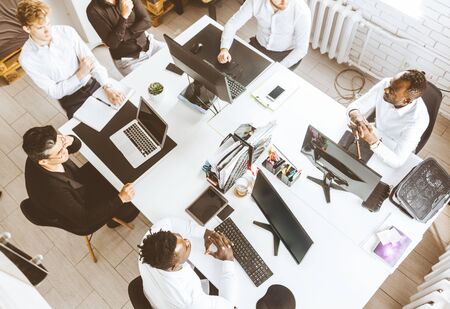 A team of young businessmen working and communicating together in an office. Corporate businessteam and manager in a meetingの写真素材