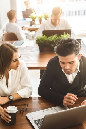 A team of young businessmen working and communicating together in an office. Corporate businessteam...