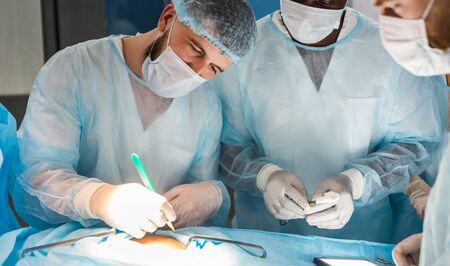 The senior surgeon in the operating room, where the patient is waiting for him, and he begins the...