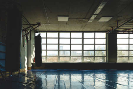 The interior of the gym and a place for group classes. Silhouette photo in front of the windowの写真素材