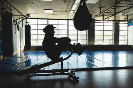 Strength training of a muscular young athlete in the gymの写真素材