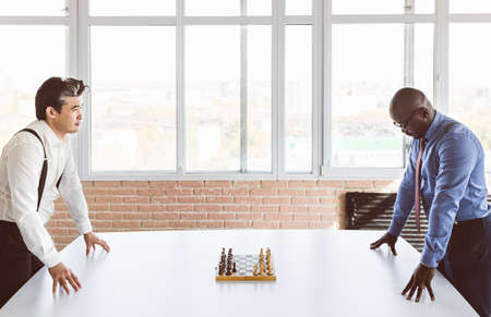 two male businessmen, rivals are playing chess. Strategy and rivalry.