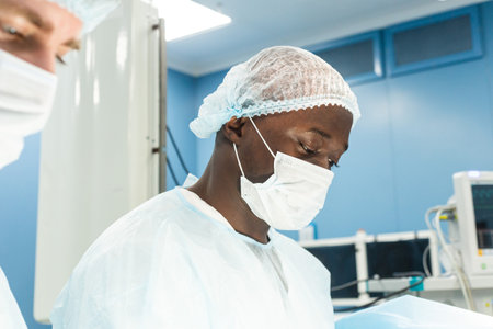 Portrait of a doctor during surgery in a uniform and medical maskの写真素材