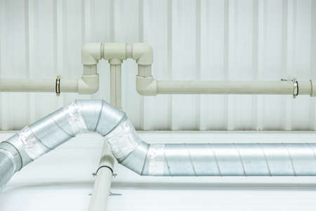 Communications from polypropylene pipes of different diameters on the walls and ceiling of the...