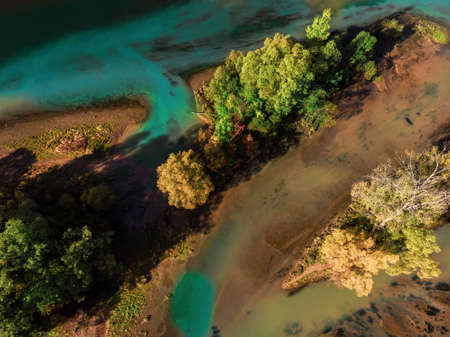 Nature from above. A river with blue water and trees on its bank. Aerial photography
