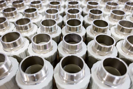 many metal pipe couplings in a pipe factory