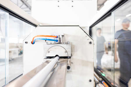 Warehouse of polypropylene pipes. Workshop with extruders for producing plastic pipes. High speed...