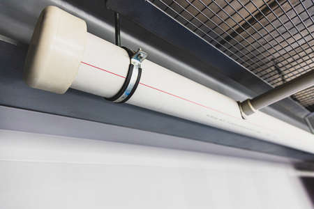 Communications from polypropylene pipes of different diameters on the walls and ceiling of the...