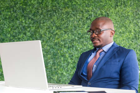 portrait of afroamerican businessman in a business suit sitting at a table in a meeting