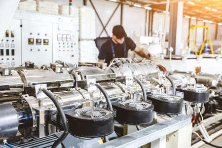 Workshop with extruders for producing plastic pipes. High speed extrusion line of water suppply and...