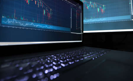 Laptop screen with stock market charts. Technical analysis and fundamental indicators of stock...