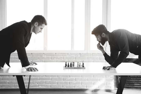 two male businessmen, rivals are playing chess. Strategy and rivalry.の写真素材