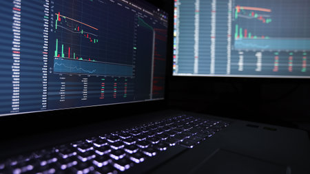 Laptop screen with stock market charts. Technical analysis and fundamental indicators of stock...