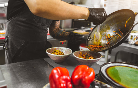 Professional chef cooking in the kitchen restaurant at the hotel, preparing dinner.の写真素材