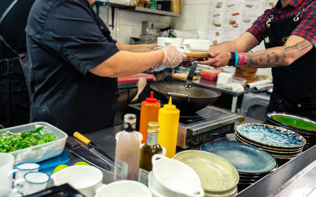 Septrember 18, 2020 Ufa, Russia: Professional chef cooking in the kitchen restaurant at the hotel,...
