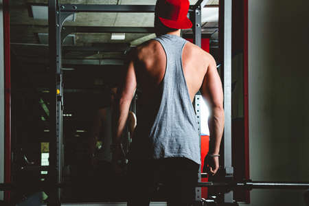 Strength training of a muscular young athlete in the gym. Stamina and perseveranceの写真素材
