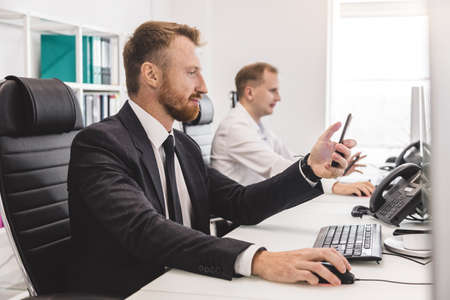 Employees of the company work at computers in the office. Interaction in the process of work and...