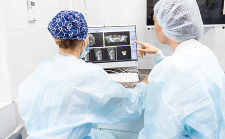 Dentistry concept. Professional dental services and modern equipment without pain. The doctor consults with the patient and displays images of the oral cavity on the monitor. treatment planの写真素材