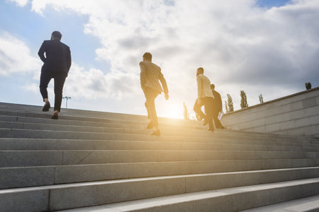 Business people climb the steps of the city stairs. impersonal rising up. Career growth and advancement. Increasing and improving skills. Salary increaseの写真素材
