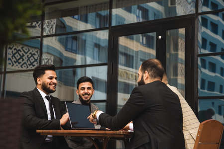 Business people outdoors. Employee meeting. Conversation and interaction of partners. Workers...