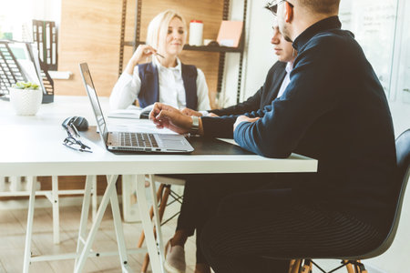 A team of young businessmen working and communicating together in an office. Corporate businessteam...