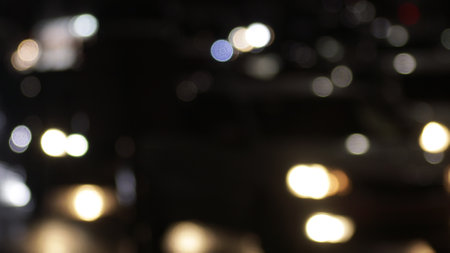 Blurred defocused image of evening car traffic in a big city. Cars in motion and standing in traffic...