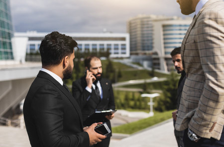 Business people outdoor meeting. Portrait of a business man against the background of a group of people and buildings of the city centerの写真素材