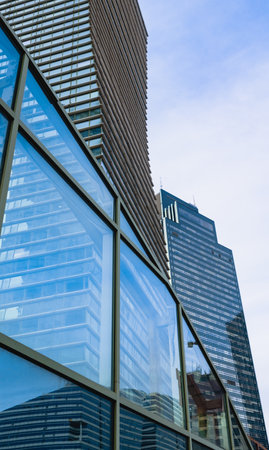 Glass office building exterior against the skyの写真素材
