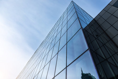 Glass office building exterior against the skyの写真素材